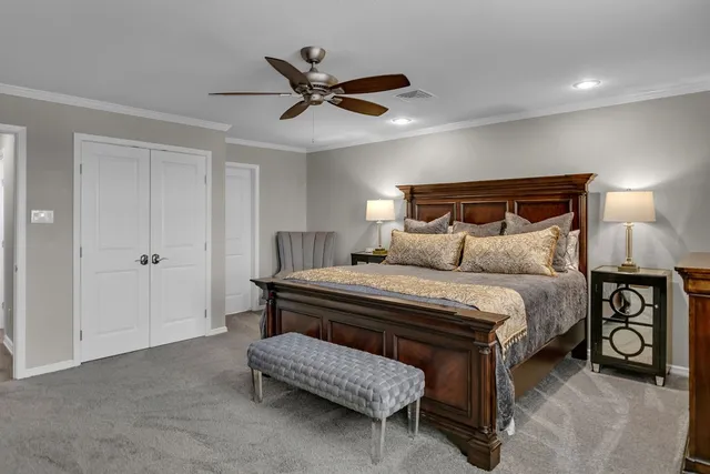a bedroom with a bed and a chandelier