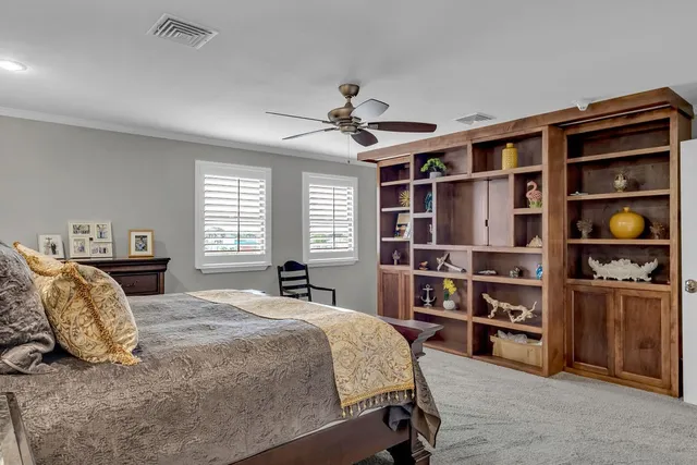 a bedroom with a bed a dresser and a book shelf