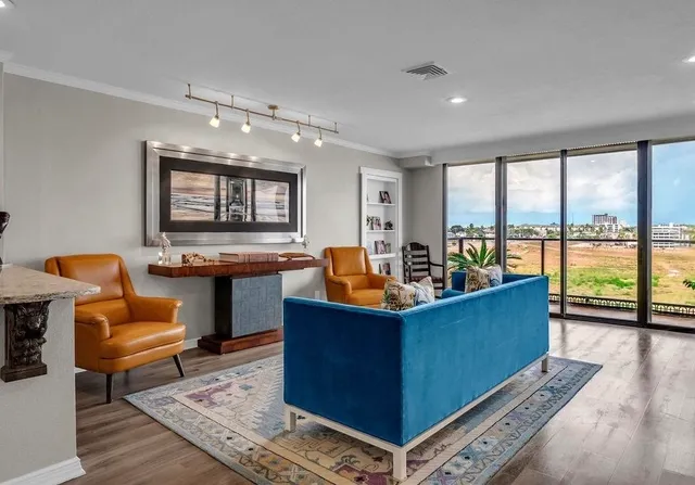 a living room with furniture and a view of kitchen