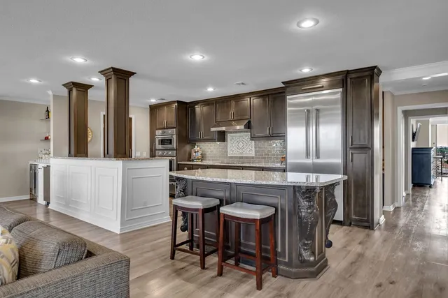 a kitchen with kitchen island granite countertop wooden cabinets and counter space