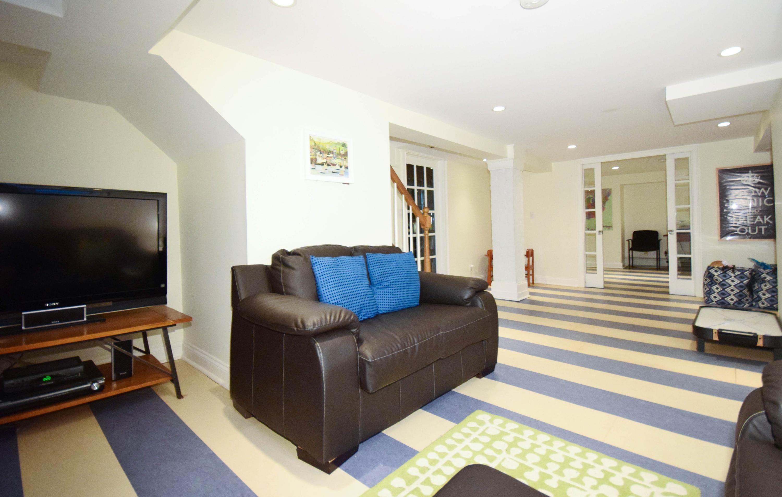 35 Ridgeley Street Darien, CT 06820 - Photo 21 of 25 a living room with furniture and a flat screen tv