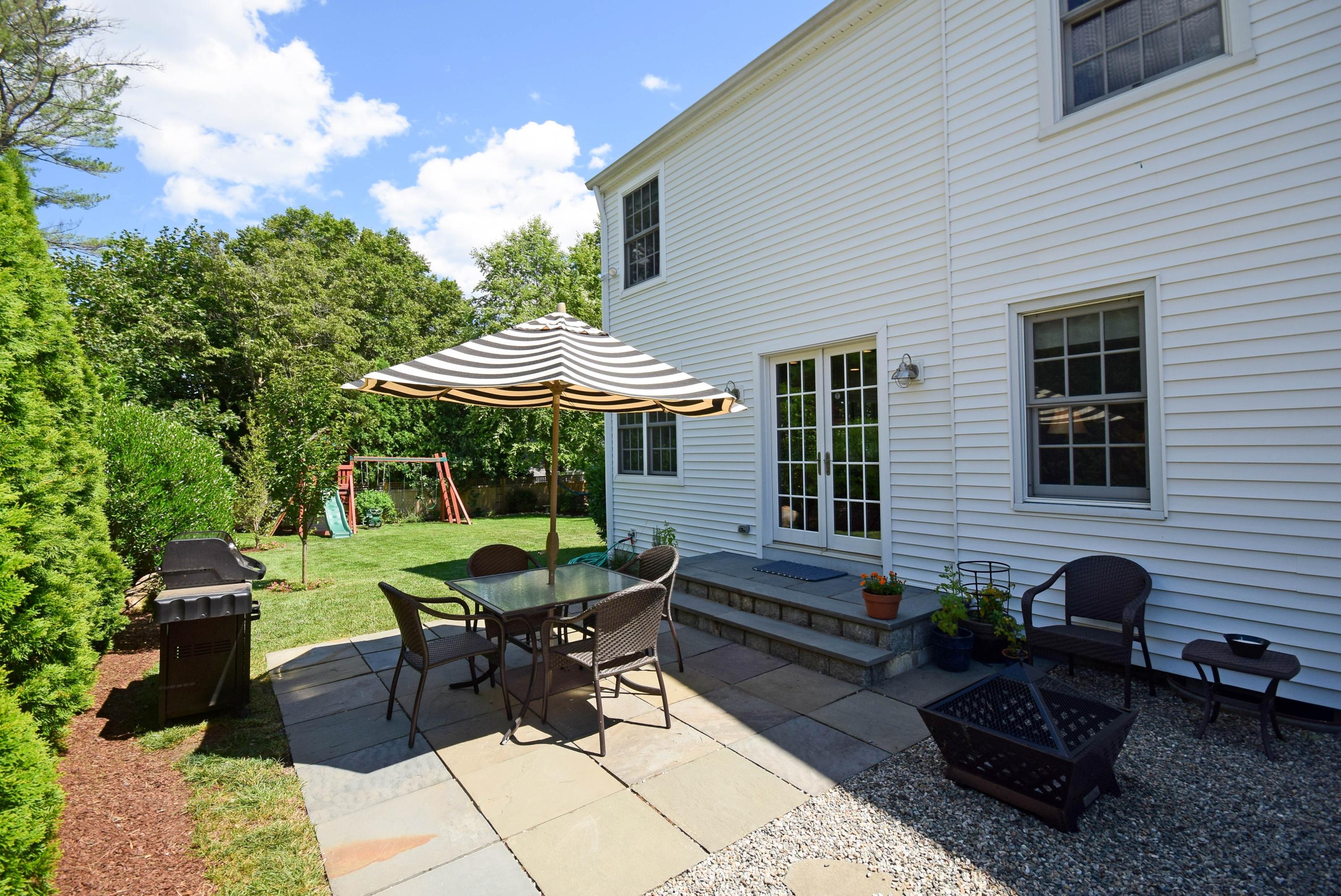 35 Ridgeley Street Darien, CT 06820 - Photo 25 of 25 a backyard of a house with outdoor seating