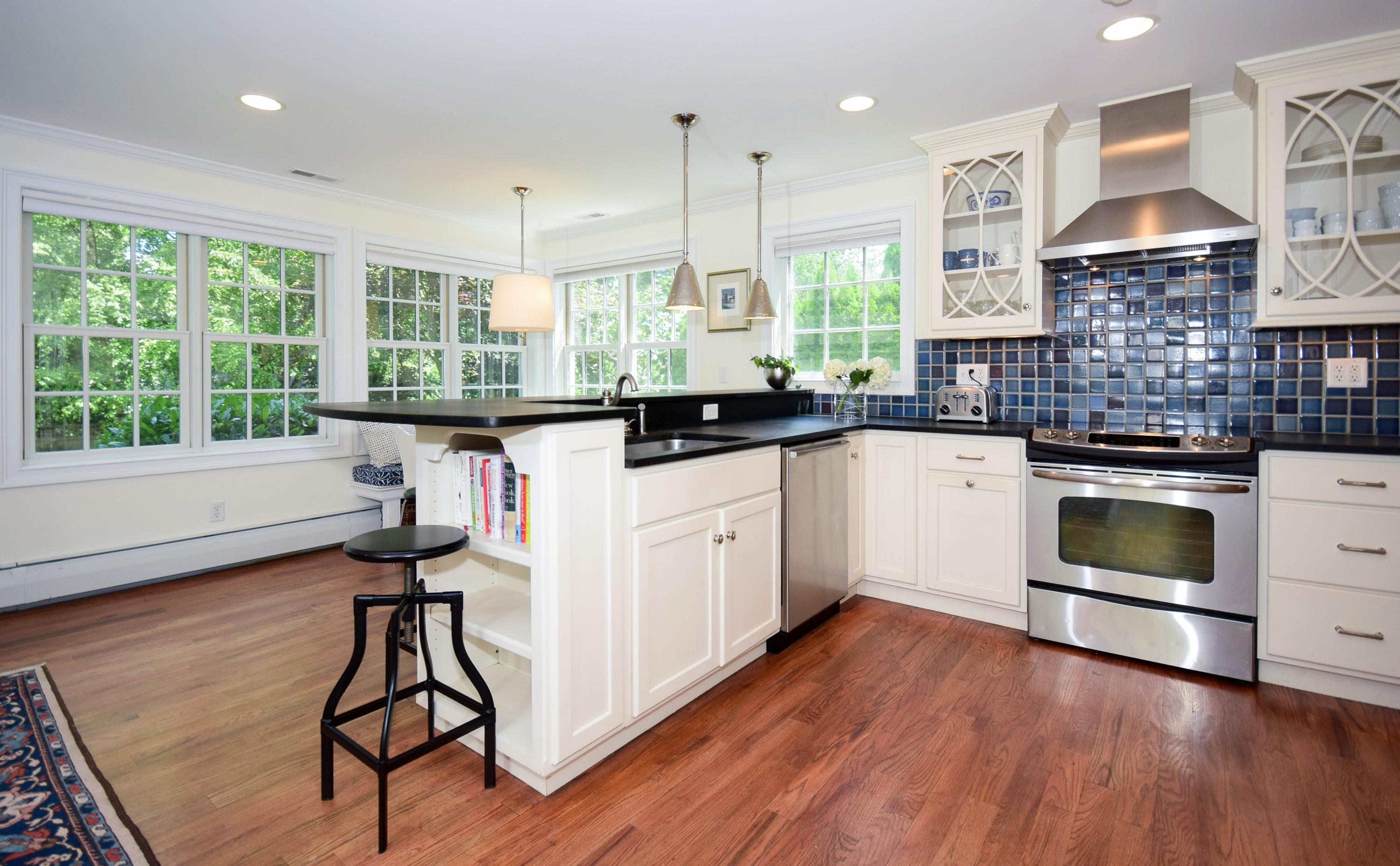 35 Ridgeley Street Darien, CT 06820 - Photo 9 of 25 a kitchen with a sink a stove and cabinets