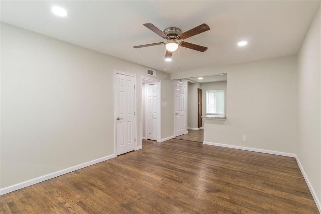 4714 Old Benbrook Road Fort Worth, TX 76116 - Photo 3 of 15 an empty room with wooden floor and windows