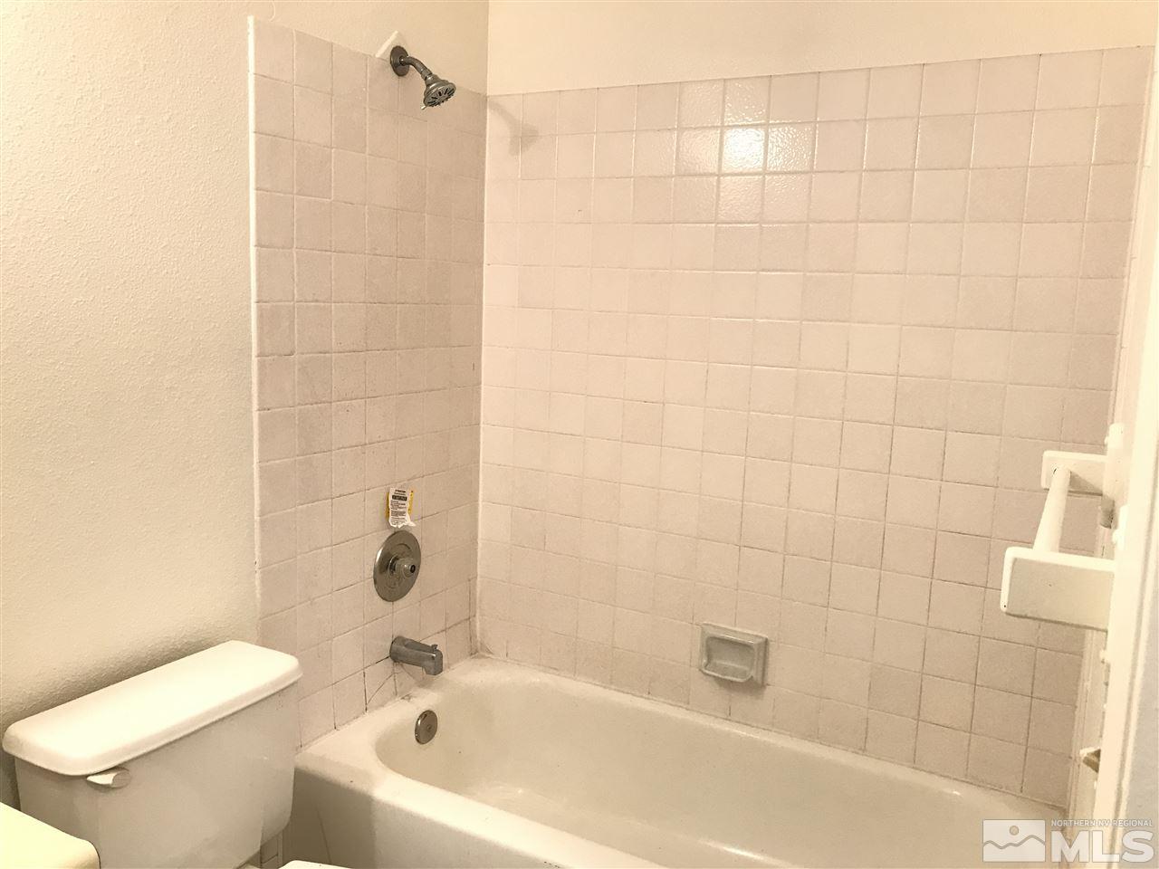 2101 Highview Court, Unit 7 Reno, NV 89512 - Photo 12 of 14 a white bath tub sitting next to a white toilet