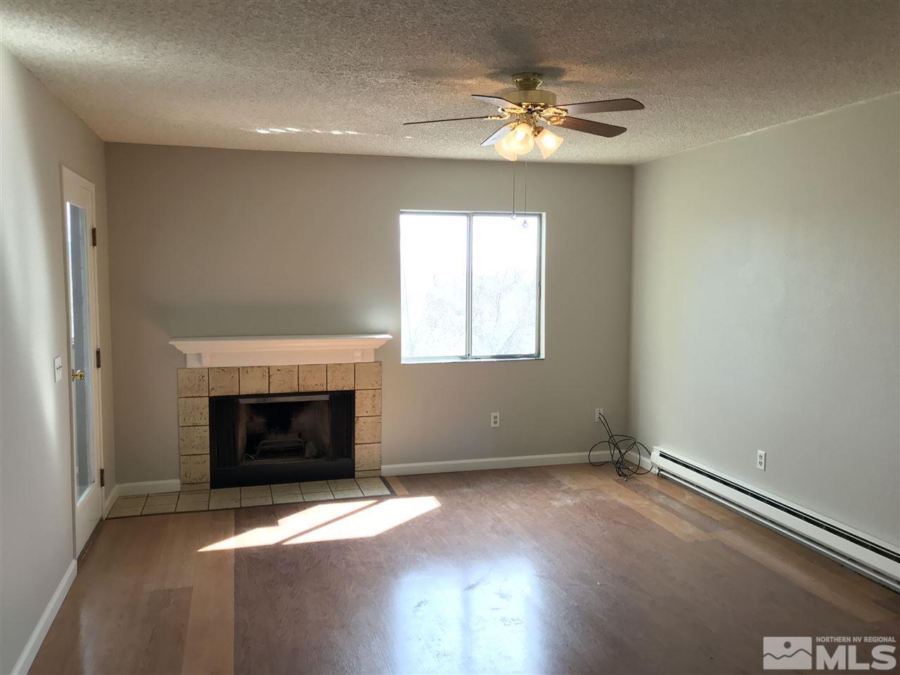 2101 Highview Court, Unit 7 Reno, NV 89512 - Photo 2 of 14 an empty room with windows and fireplace
