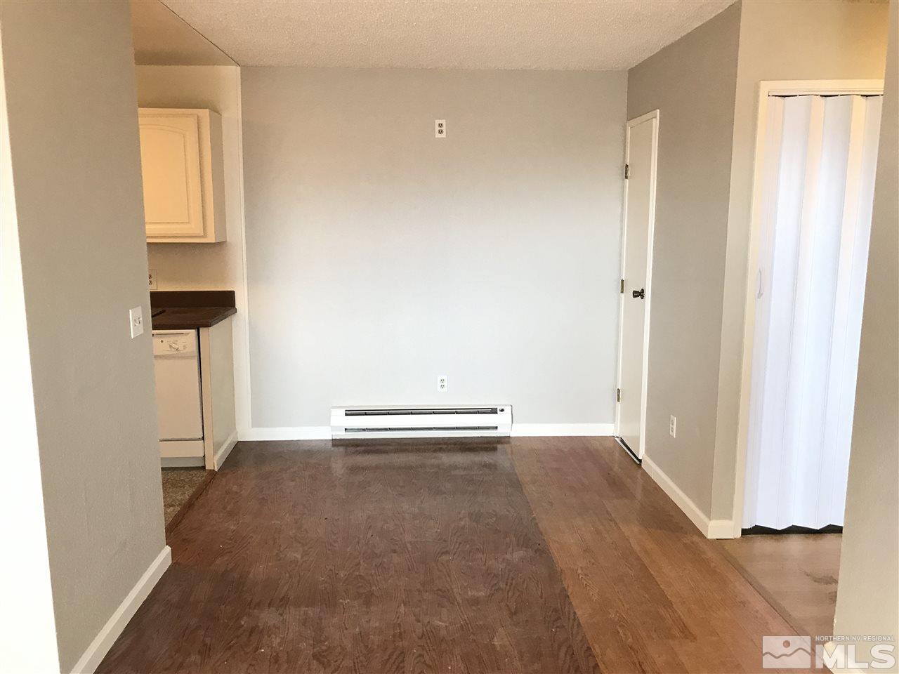2101 Highview Court, Unit 7 Reno, NV 89512 - Photo 3 of 14 a view of an empty room with wooden floor and a window