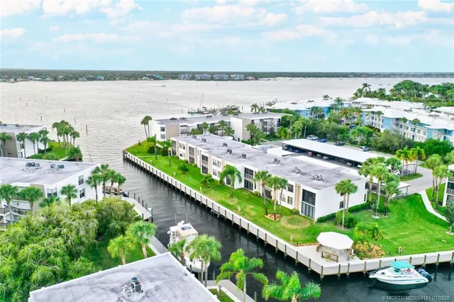 a living room with furniture a clock on wall and a sink