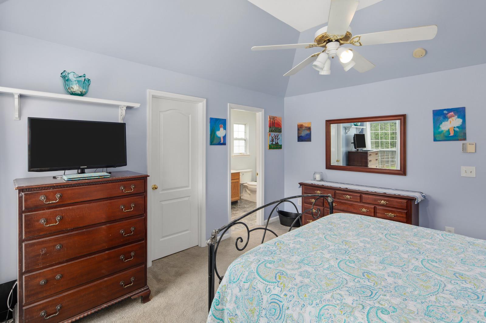 3028 Stone Bridge Road Antioch, TN 37013 - Photo 13 of 30 a bedroom with a bed a flat screen tv and a dresser