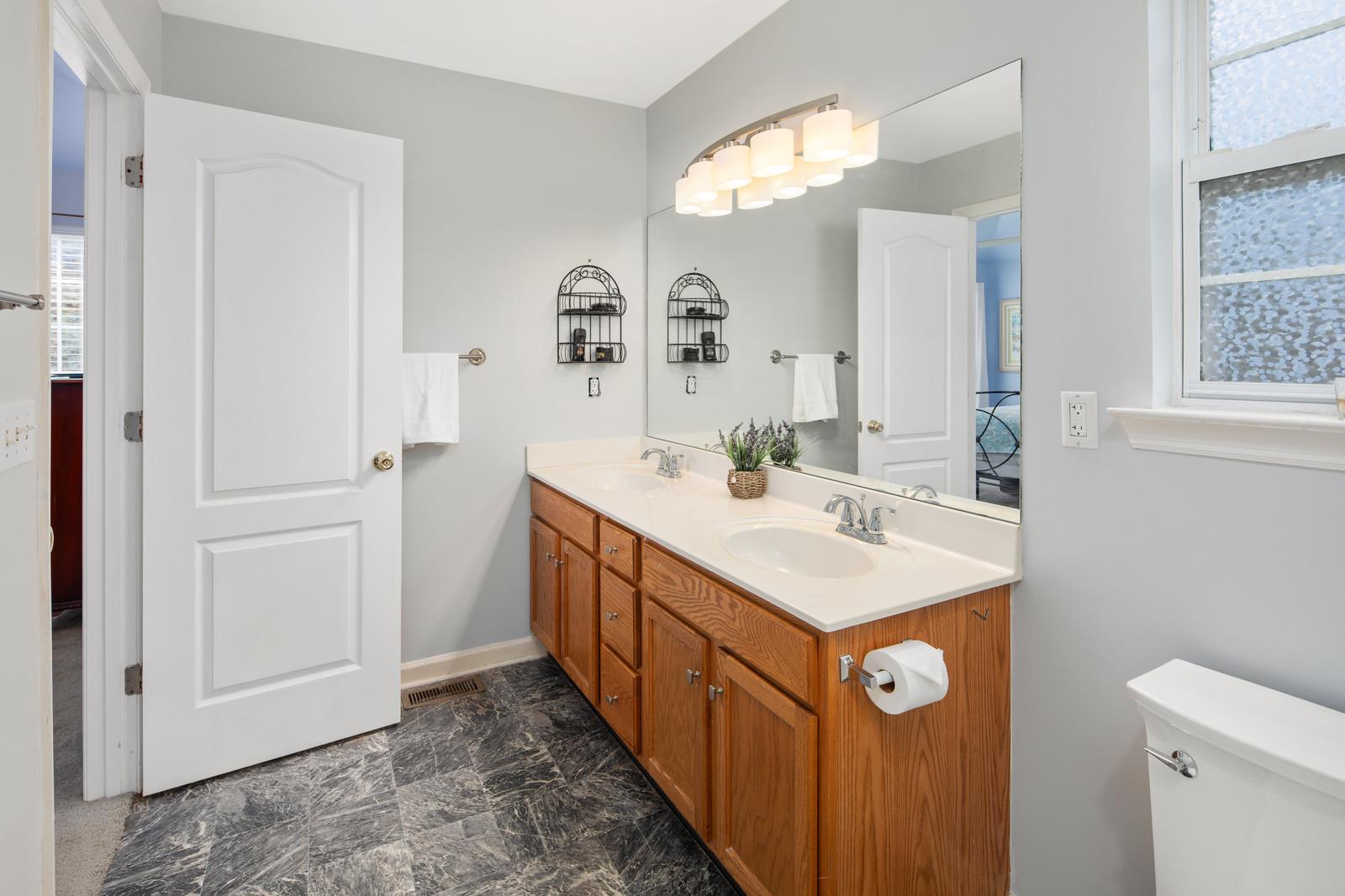 3028 Stone Bridge Road Antioch, TN 37013 - Photo 14 of 30 a bathroom with a sink a mirror and a toilet