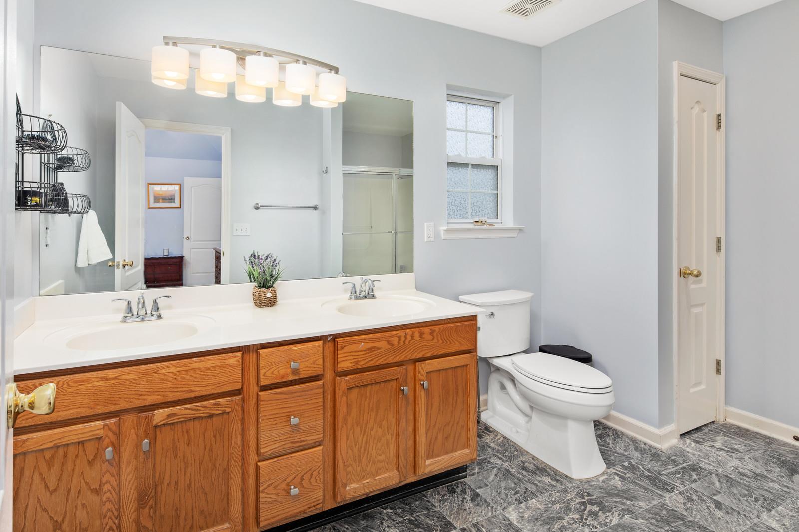 3028 Stone Bridge Road Antioch, TN 37013 - Photo 16 of 30 a bathroom with a granite countertop toilet sink and mirror