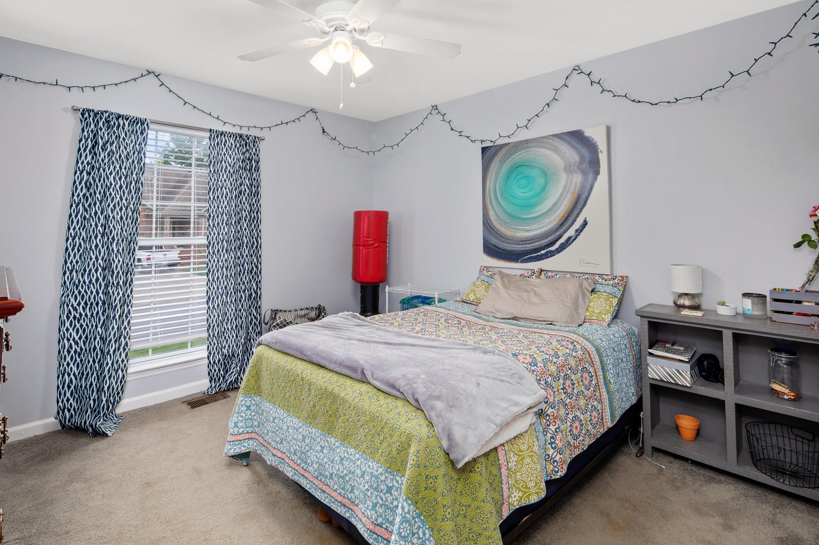 3028 Stone Bridge Road Antioch, TN 37013 - Photo 17 of 30 a bedroom with a bed and a chandelier