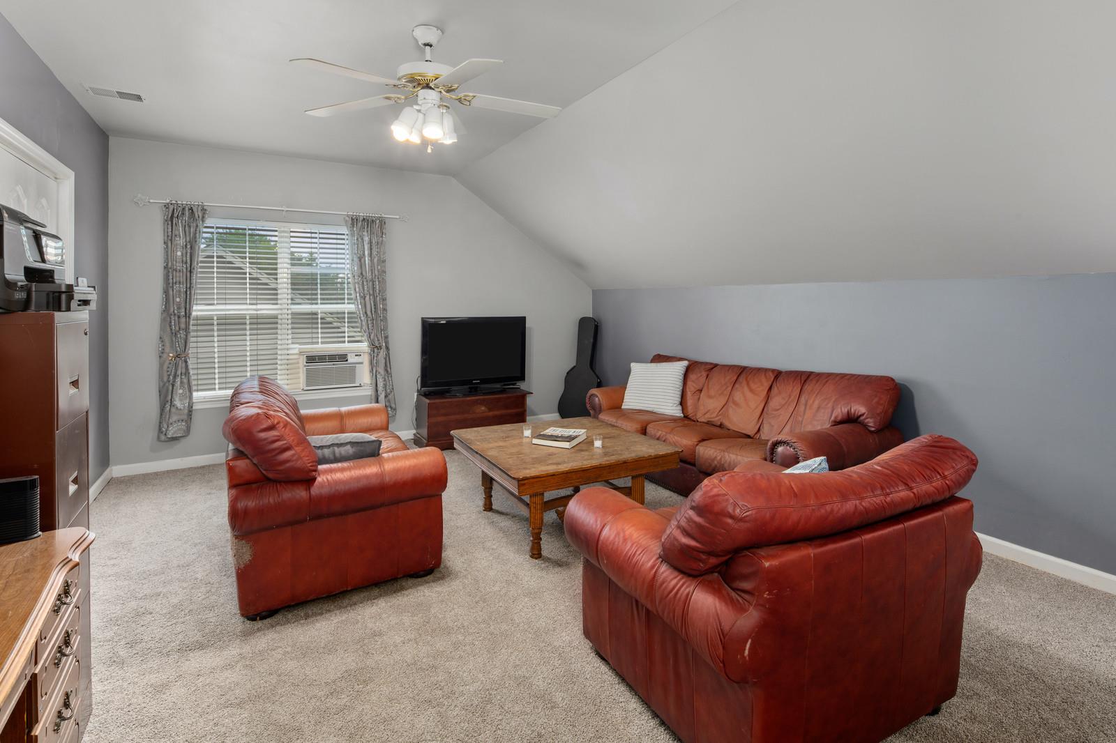 3028 Stone Bridge Road Antioch, TN 37013 - Photo 21 of 30 a living room with furniture a flat screen tv and a window