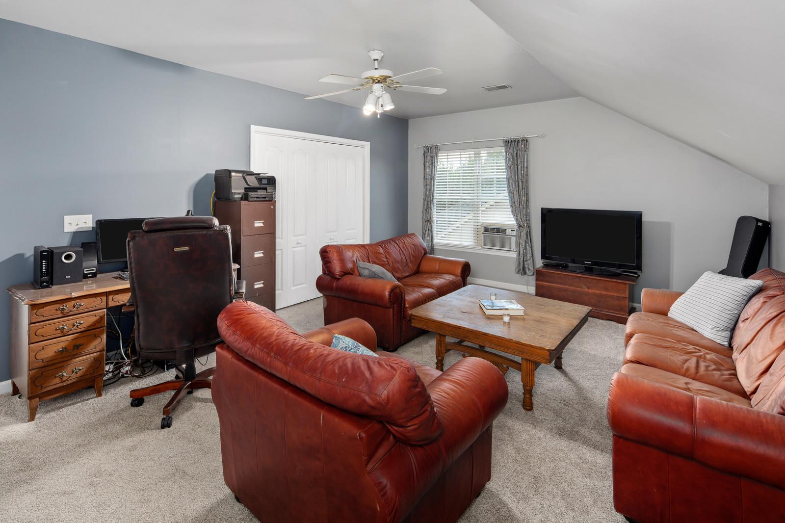 3028 Stone Bridge Road Antioch, TN 37013 - Photo 22 of 30 a living room with furniture a flat screen tv and a window