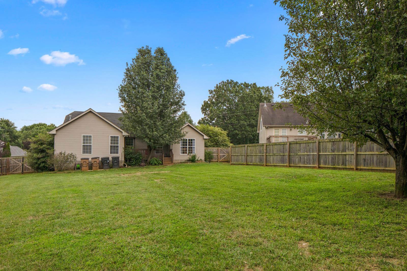 3028 Stone Bridge Road Antioch, TN 37013 - Photo 28 of 30 a house that is sitting in the grass with large trees and plants