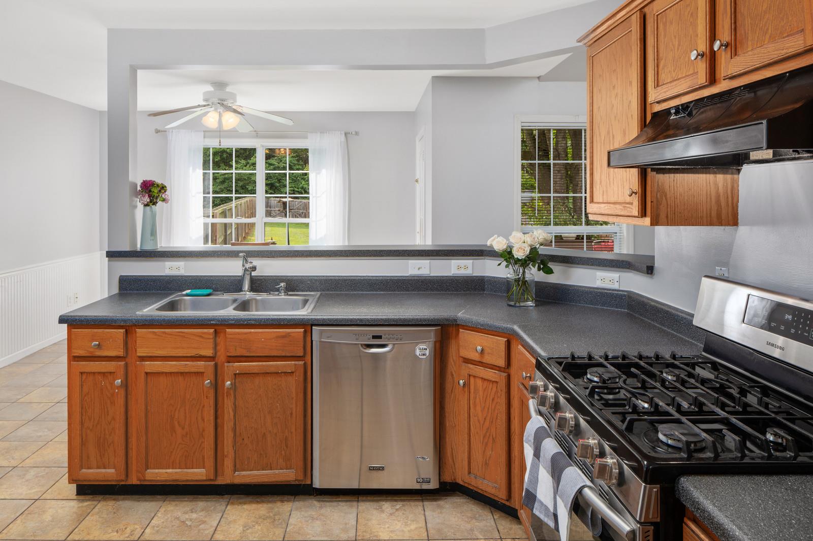 3028 Stone Bridge Road Antioch, TN 37013 - Photo 5 of 30 a kitchen with granite countertop a sink a stove and cabinets