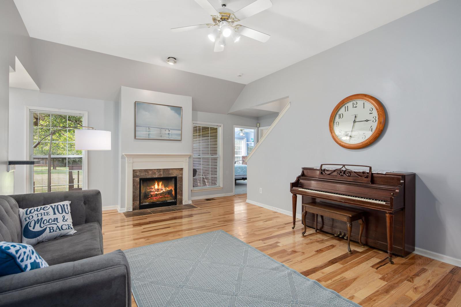 3028 Stone Bridge Road Antioch, TN 37013 - Photo 10 of 30 a living room with furniture a clock and a fireplace