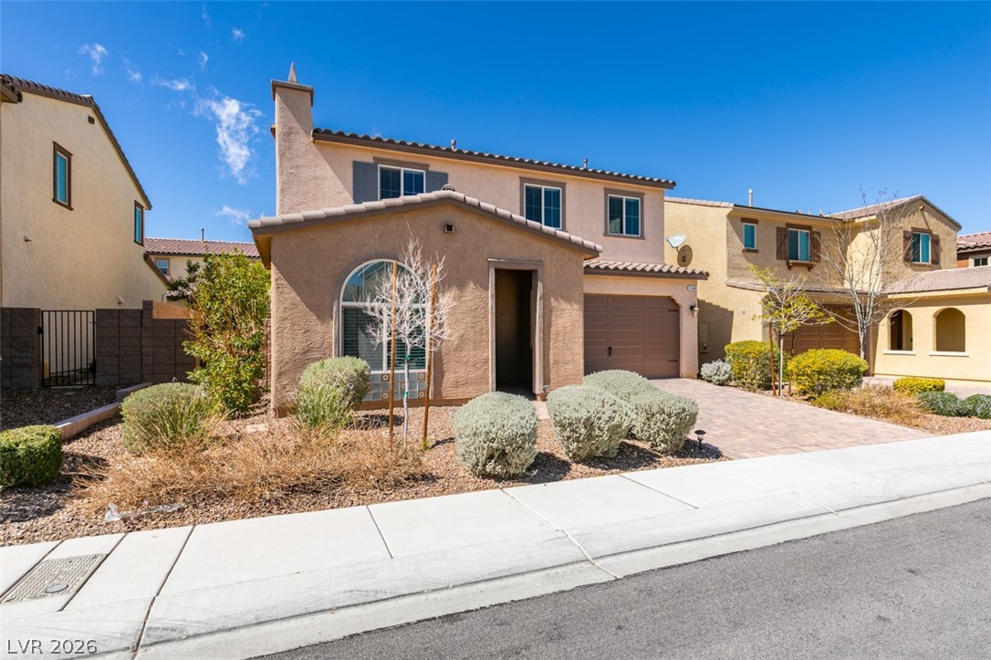 2549 Sable Ridge Street Henderson, NV 89044 - Photo 2 of 8 A charming facade with a covered entry and attached garage, offering an inviting curb appeal.