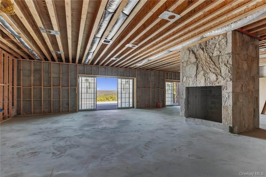 55 Ridgecrest Road Putnam Valley, NY 10537 - Photo 11 of 25 a view of an empty room with a fireplace and a window