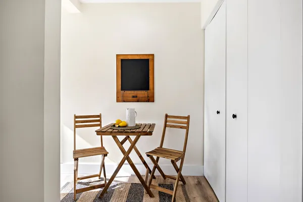 a view of a room that has a table and chair in it