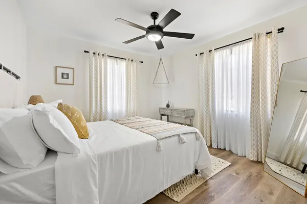 a bedroom with a bed and a chandelier
