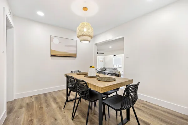 a view of a dining room with furniture and wooden floor