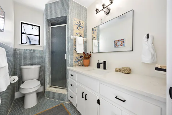 a bathroom with a toilet sink and mirror