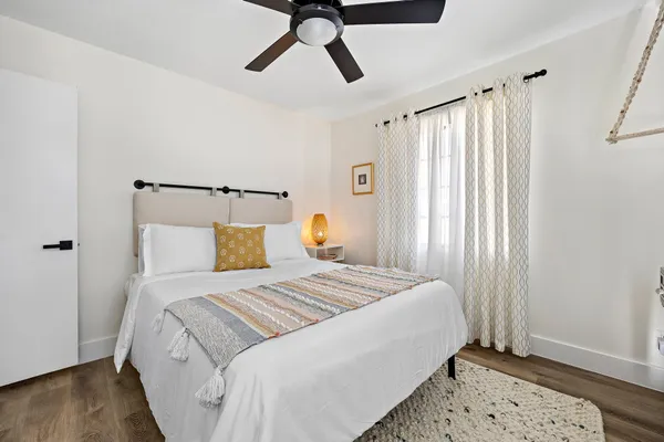 a bedroom with a bed and wooden floor