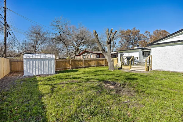 a view of a backyard with a garden and deck