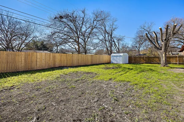 a view of a backyard with large trees