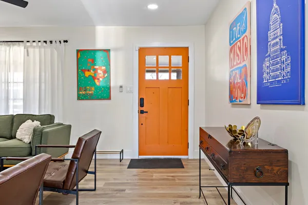 a living room with furniture and painting on the wall