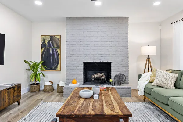 a living room with furniture and a fireplace