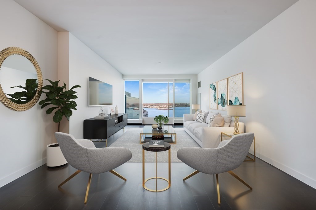 a living room with furniture a chandelier and a potted plant