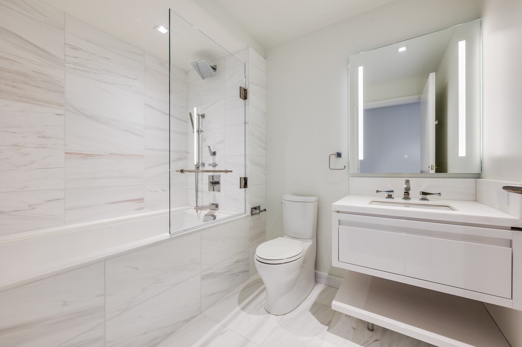 150 Seaport Boulevard, Unit 17D Boston, MA 02210 - Photo 11 of 24 a bathroom with a sink a toilet and shower