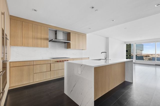 a kitchen with stainless steel appliances granite countertop a sink stove and cabinets
