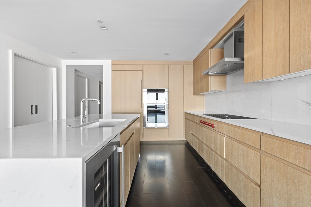 150 Seaport Boulevard, Unit 17D Boston, MA 02210 - Photo 5 of 24 a kitchen with stainless steel appliances granite countertop a sink stove and cabinets