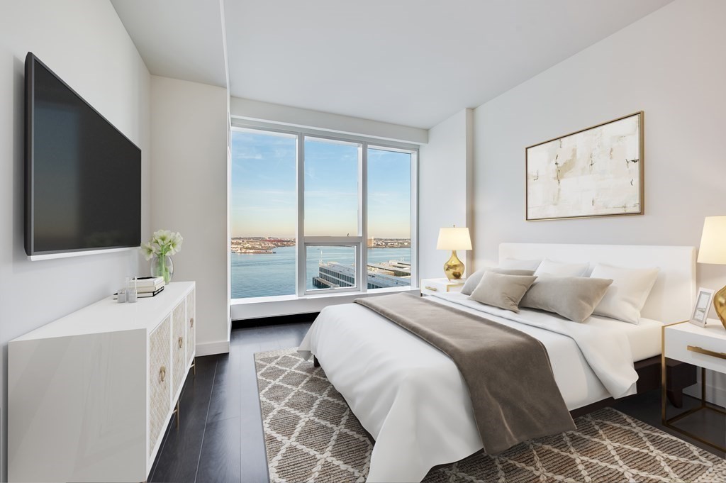 150 Seaport Boulevard, Unit 17D Boston, MA 02210 - Photo 6 of 24 a bedroom with a bed and a flat screen tv