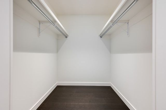 a bathroom with a tub sink double vanity and shower