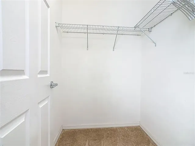 a bathroom with a granite countertop sink toilet and mirror