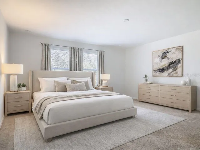 a bedroom with a bed a table and a lamp