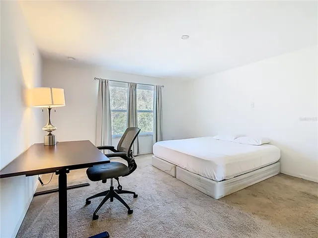 a bedroom with a bed and cabinets
