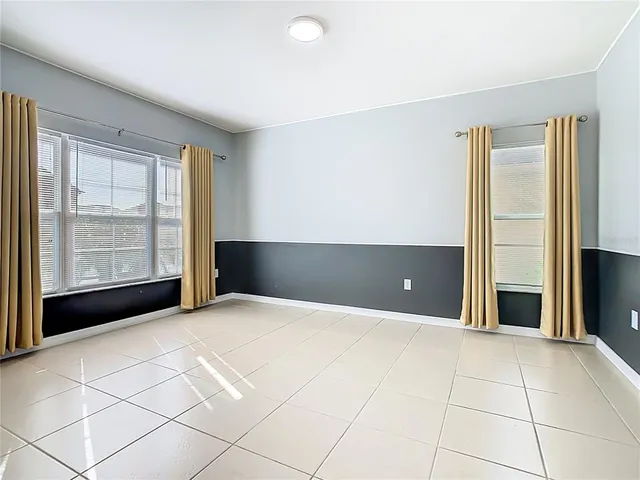 a view of a livingroom with an empty space and a window