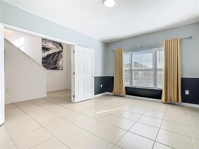 a view of an empty room with a kitchen