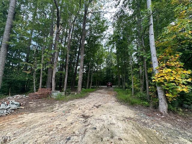 1101 Moss Road Zebulon, NC 27597 - Photo 9 of 22 a backyard of a house with lots of trees