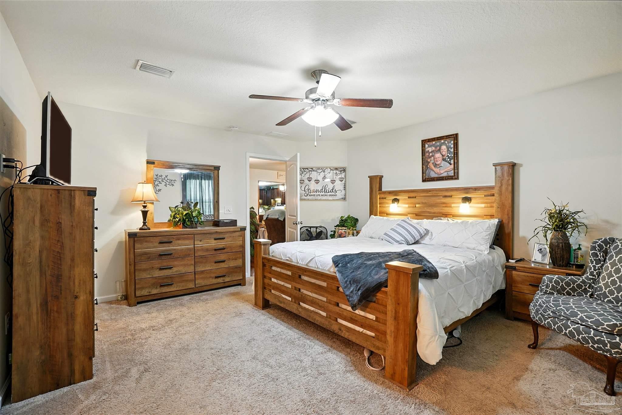 4734 Apple Field Way Pace, FL 32571 - Photo 18 of 31 a bedroom with bed and window