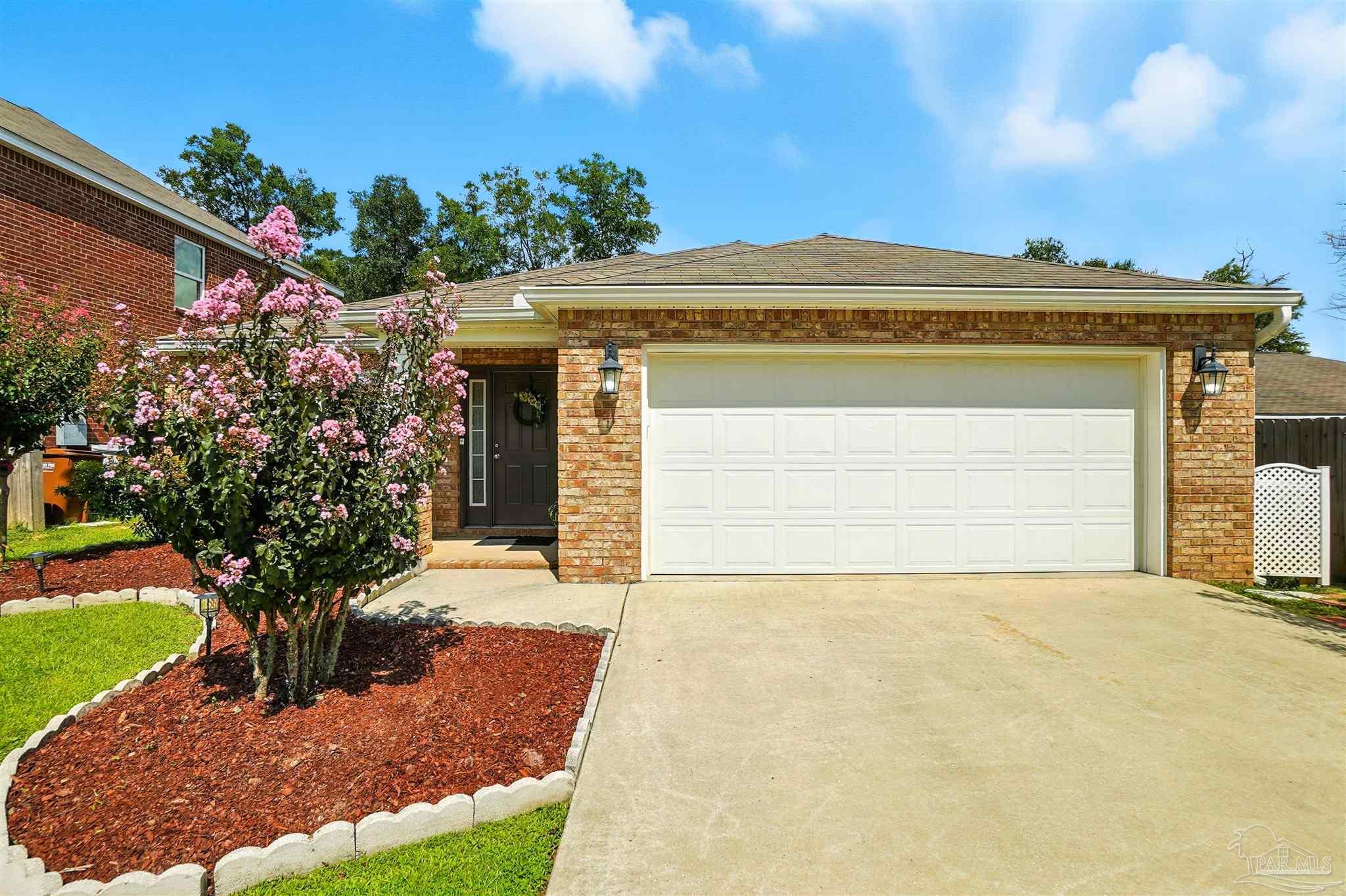4734 Apple Field Way Pace, FL 32571 - Photo 2 of 31 a front view of a house with a yard and garage