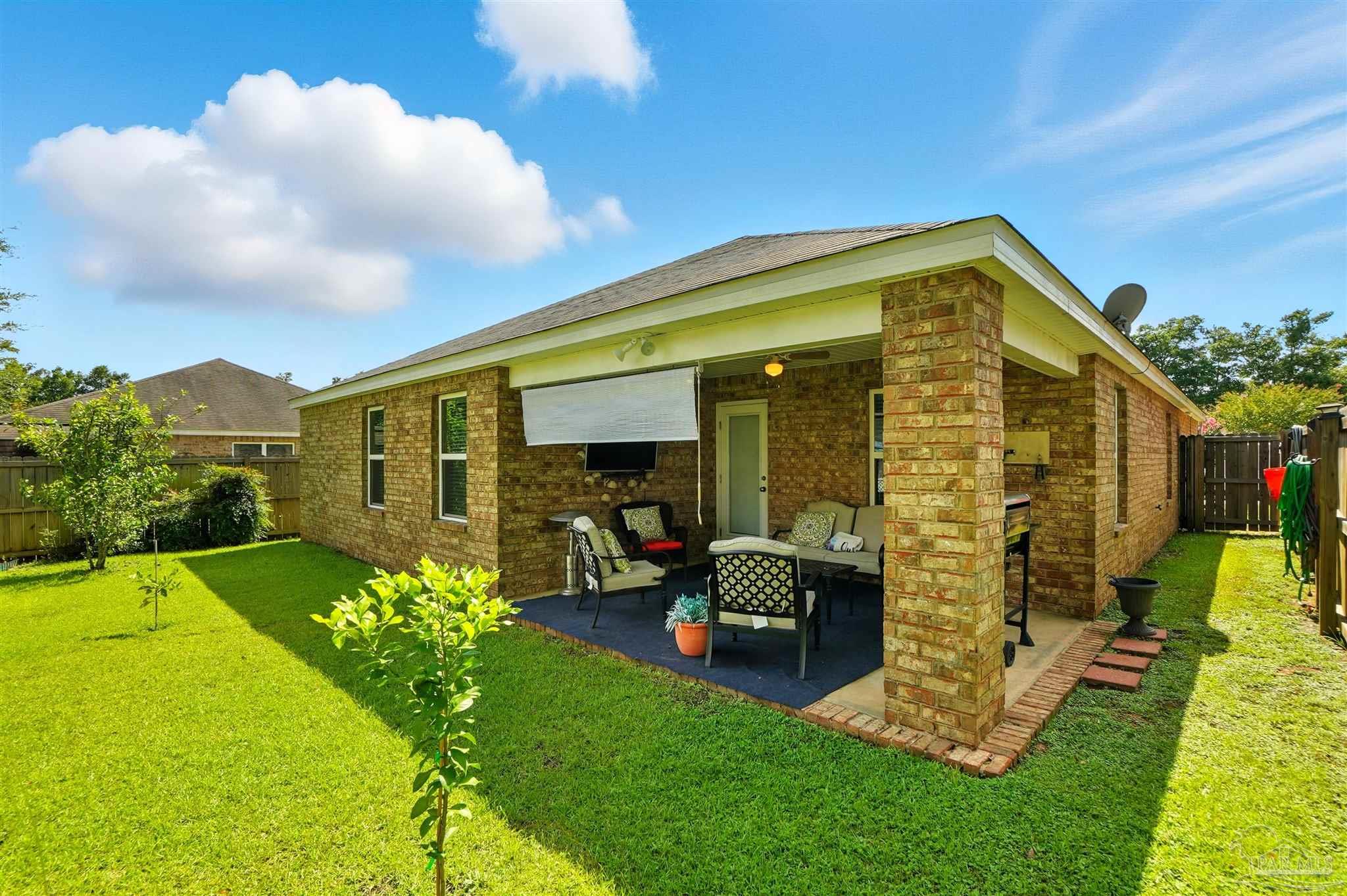 4734 Apple Field Way Pace, FL 32571 - Photo 26 of 31 a front view of house with yard
