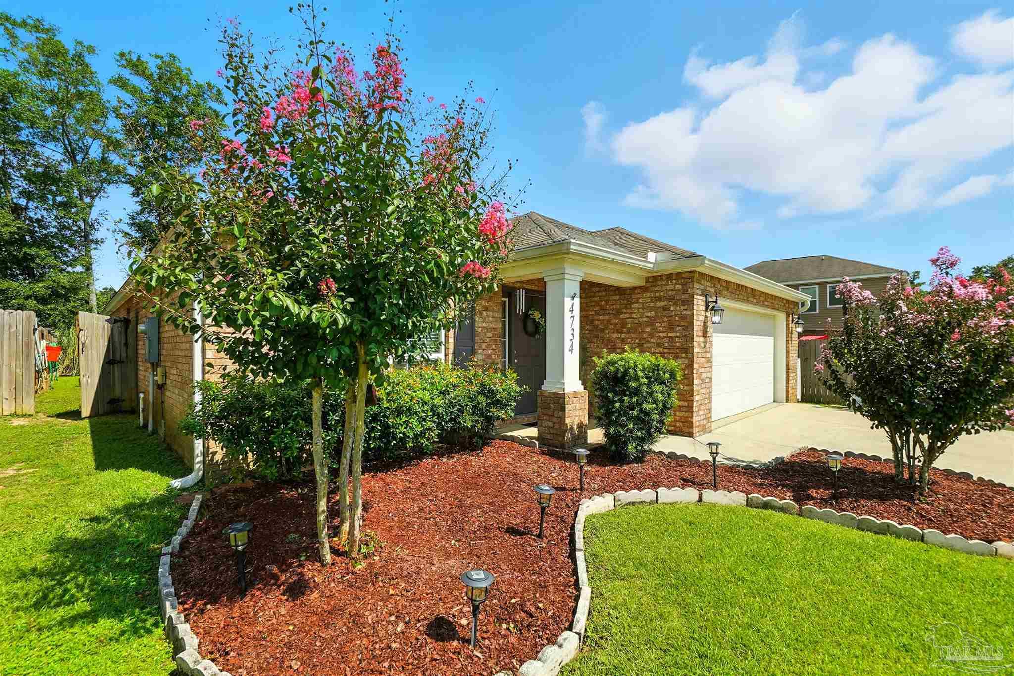 4734 Apple Field Way Pace, FL 32571 - Photo 3 of 31 a front view of a house with a yard