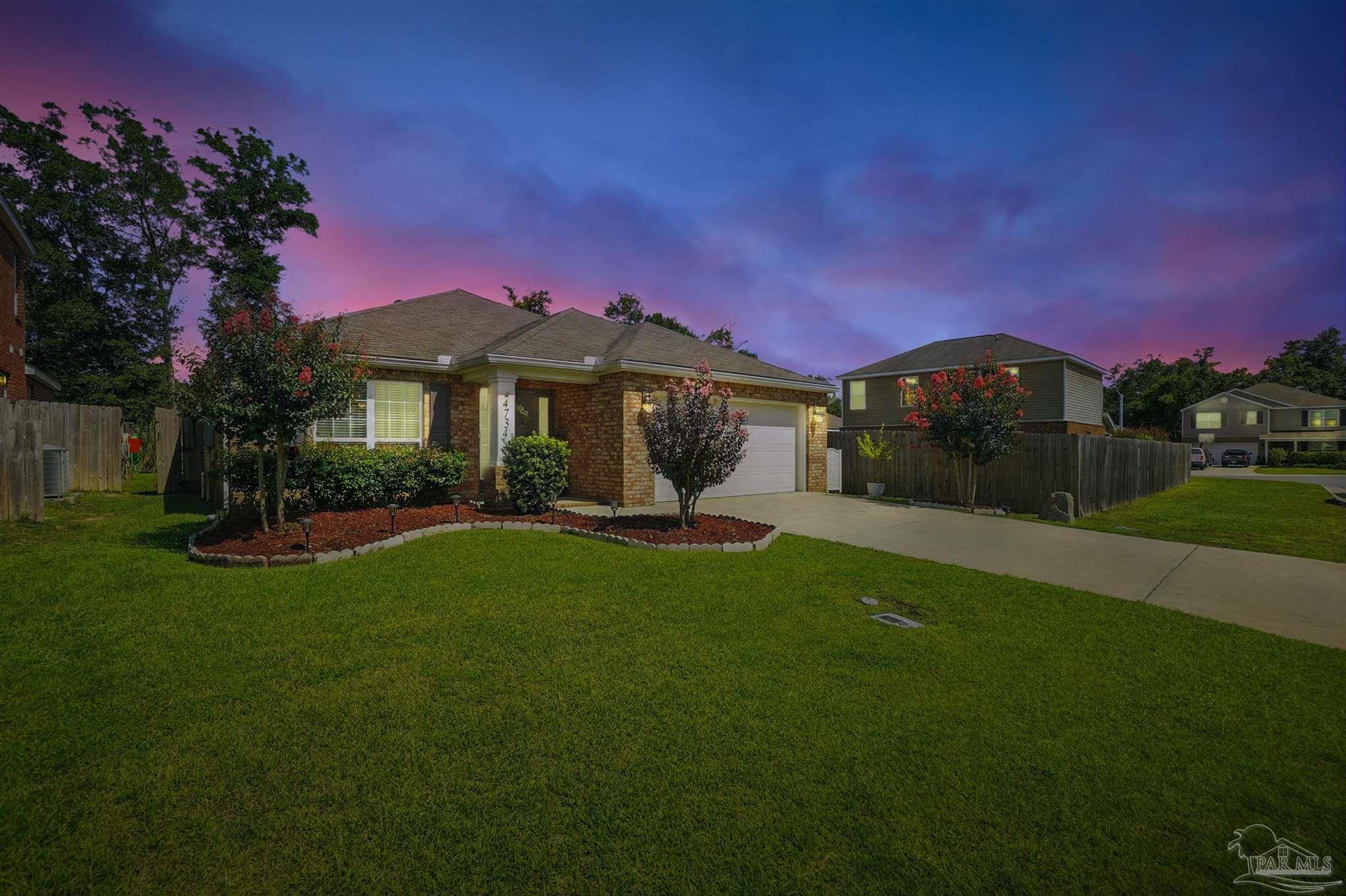 4734 Apple Field Way Pace, FL 32571 - Photo 31 of 31 a front view of a house with a garden and yard