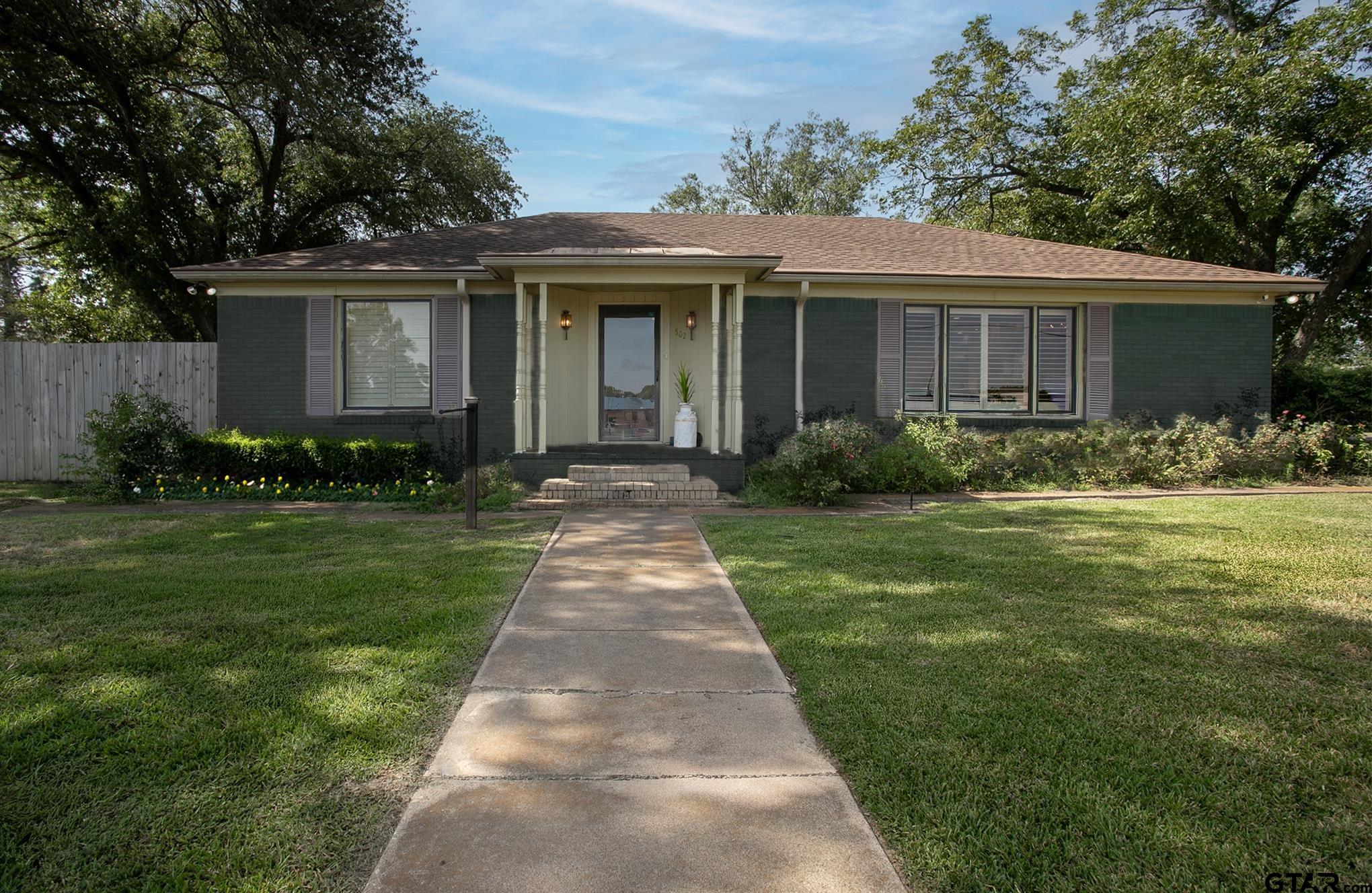 502 West Hubbard Street Lindale, TX 75771 - Photo 1 of 48 a front view of a house with garden